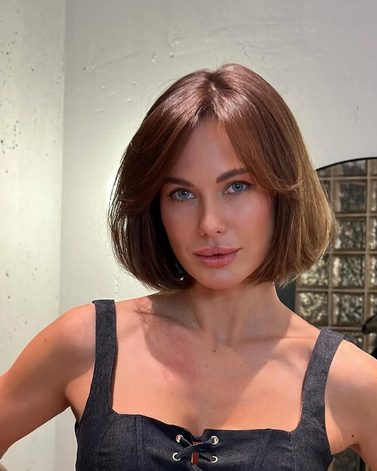 old money look with an elegant bob with bangs and middle parting